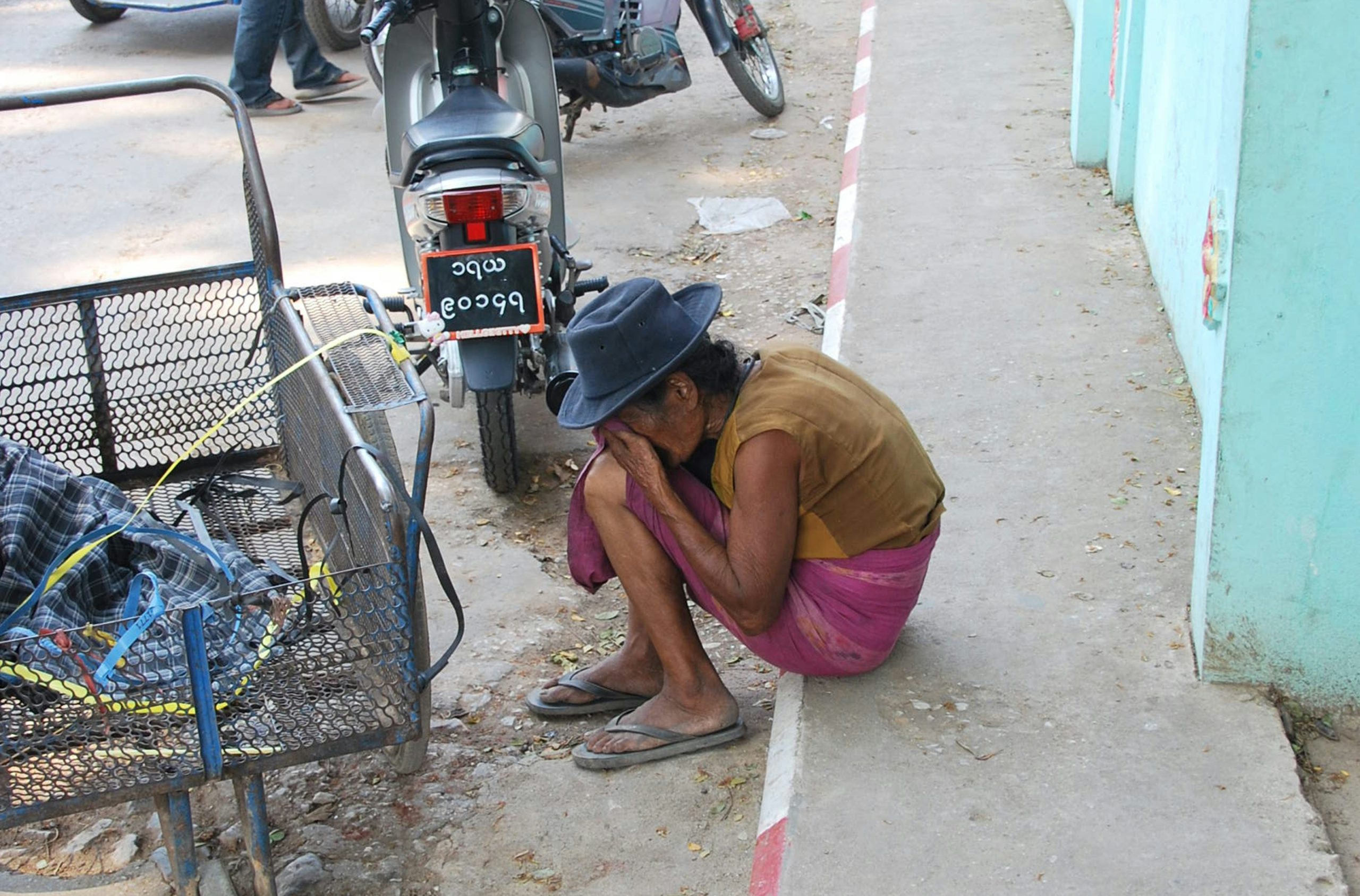 Mechanic inspecting the hydraulics of a used tractor close up focusing on connections