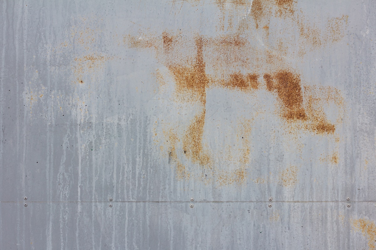 a rusted metal surface with a horse drawn on it