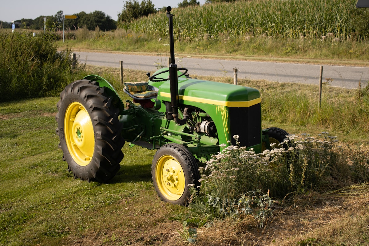 a tractor parked in a field next to a road