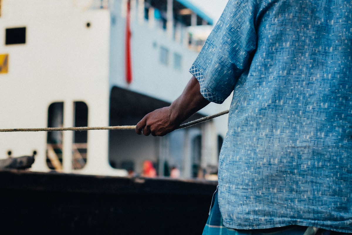 A man standing in front of a large boat