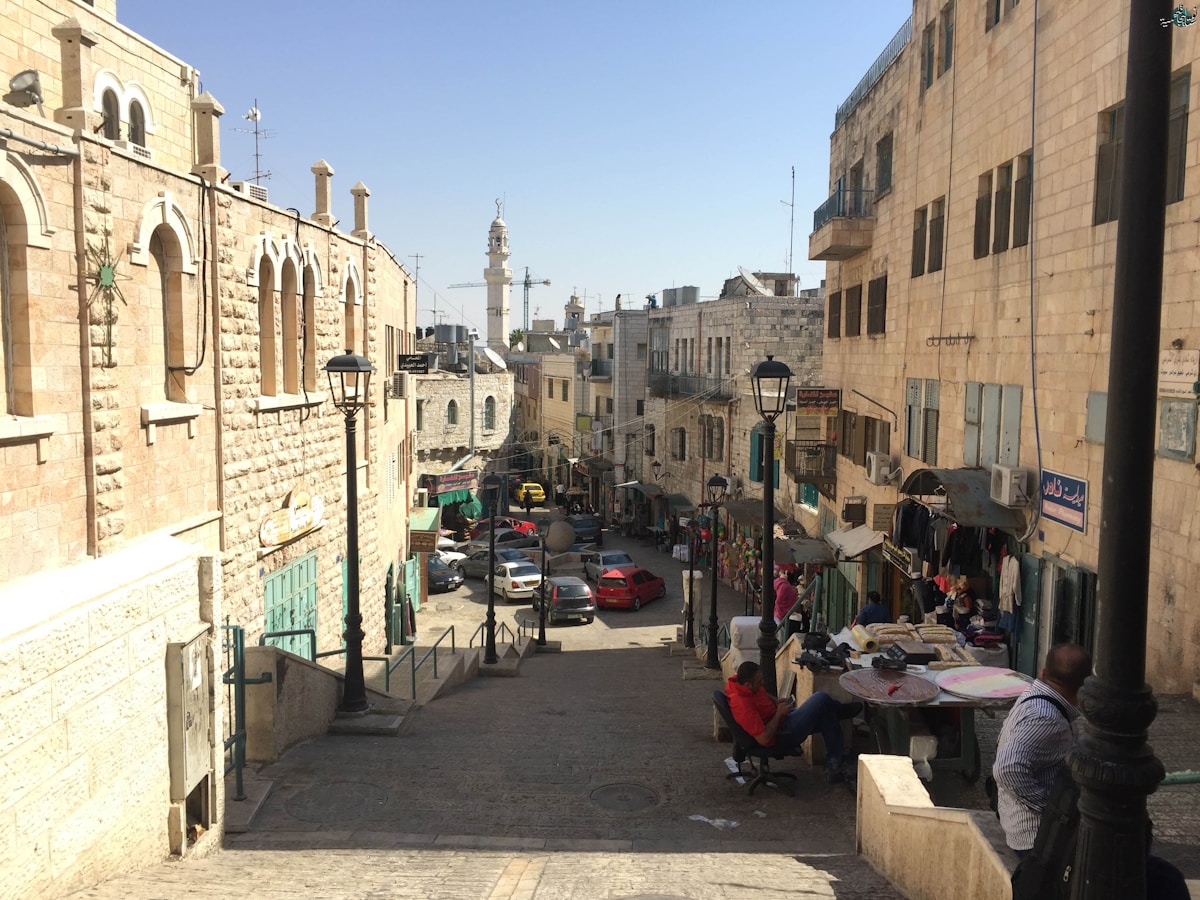 Street scene with buildings and market stalls in a town.