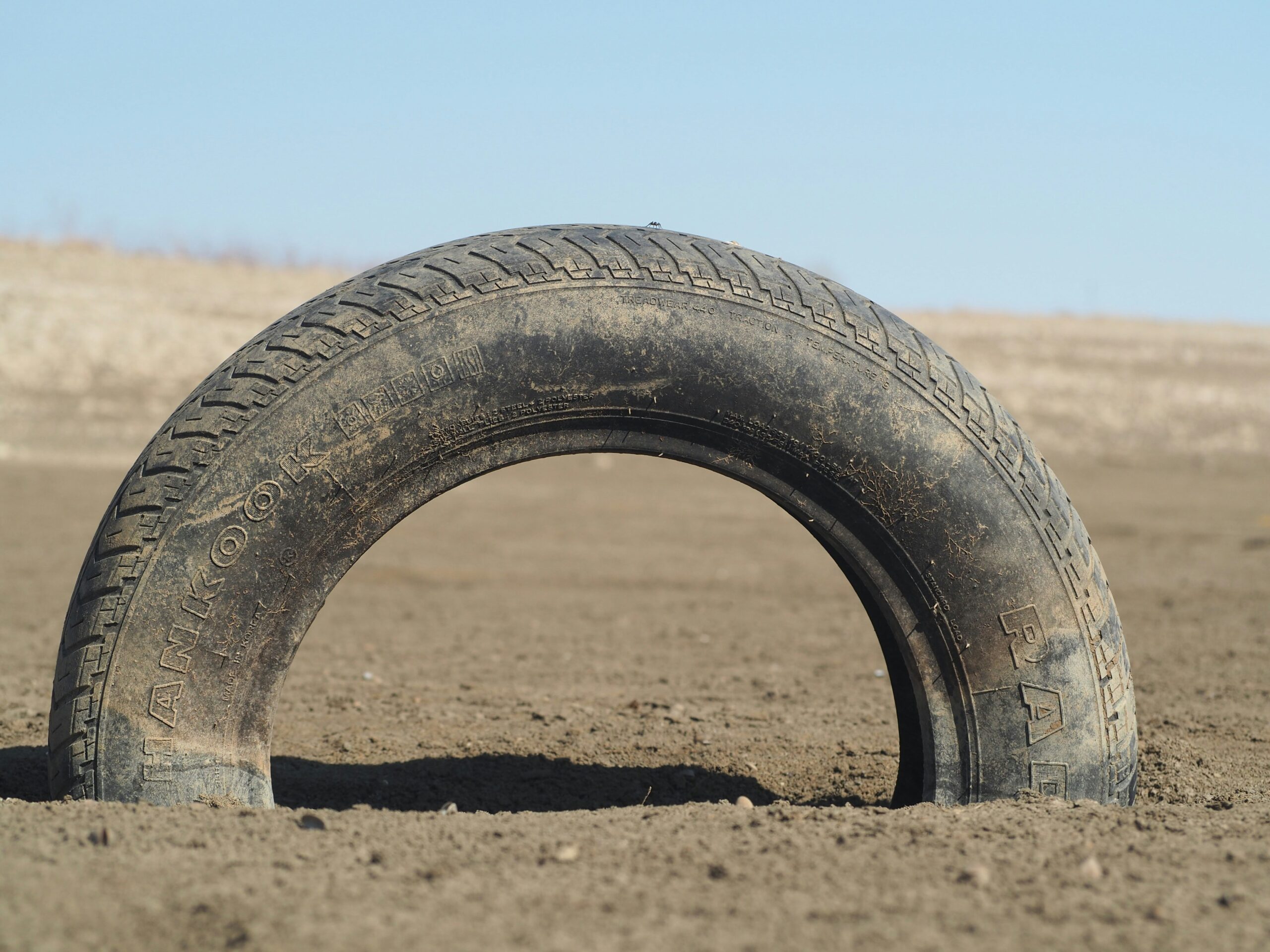 Close up of worn tractor tire tread in a field