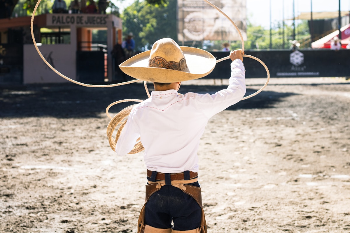 Charro with lasso in a dusty arena