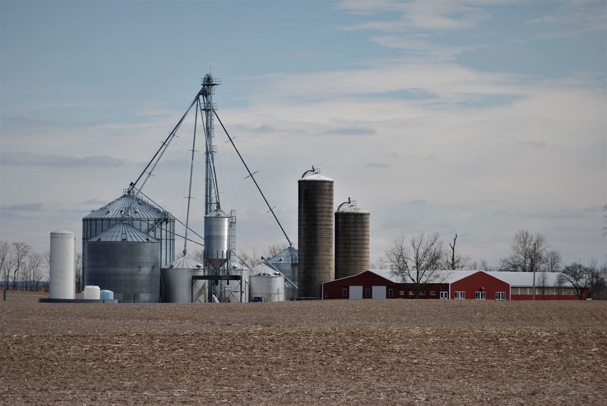 a farm with silos and silos in the distance