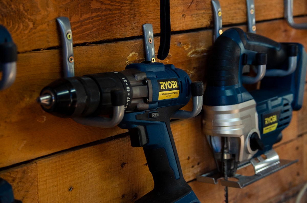 a couple of drillers are hanging on a wall